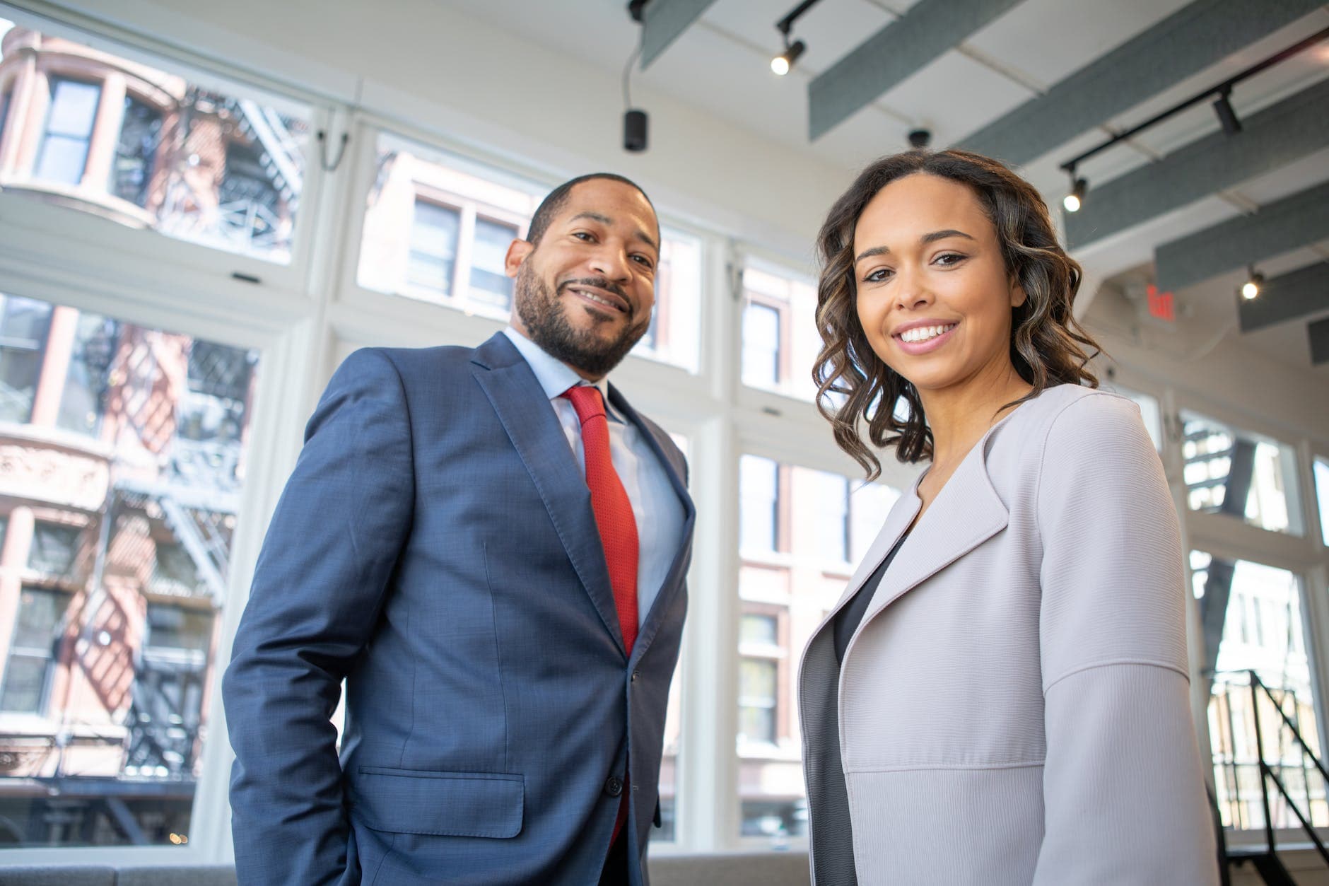 Two professionals smiling in an office