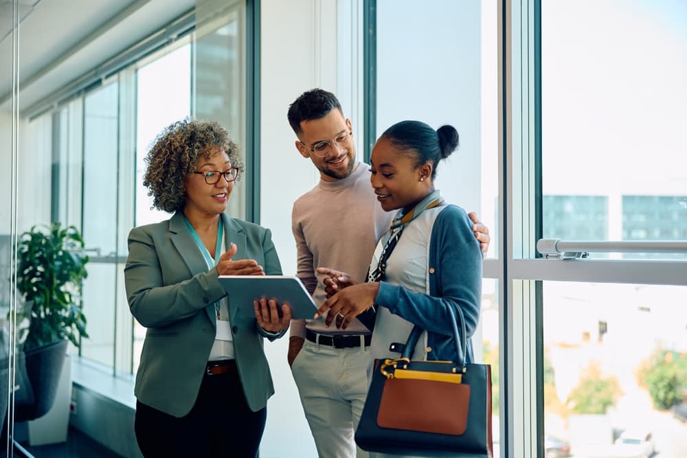 Colleagues sharing a tablet in an office
